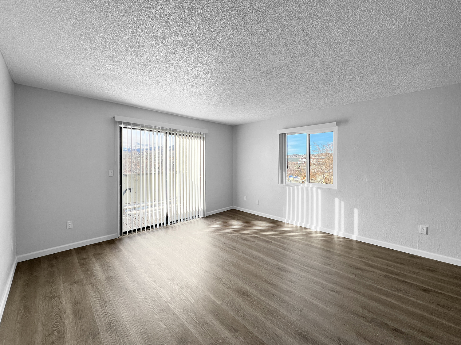 Living room and balcony at WateringWinds Apartments